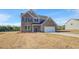 Two story brick home featuring a two car garage and classic architectural design on a large lot at 115 Felicity Pike, Locust Grove, GA 30248