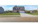 New two story brick home featuring a two car garage, well manicured lawn, and classic architectural design at 115 Felicity Pike, Locust Grove, GA 30248