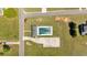 An aerial view shows a private backyard swimming pool with mature trees surrounding the house at 27 Friendship Rd, Euharlee, GA 30145