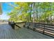 Wooden back deck with black railing and a lush tree view at 27 Friendship Rd, Euharlee, GA 30145