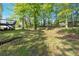 A backyard features a wooden deck and mature trees at 27 Friendship Rd, Euharlee, GA 30145