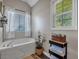 Bathroom featuring a soaking tub, stylish window treatments, and a linen tower at 27 Friendship Rd, Euharlee, GA 30145