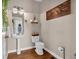 Charming half bath with pedestal sink, stylish decor, and warm hardwood flooring at 27 Friendship Rd, Euharlee, GA 30145