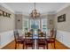 Traditional dining room featuring a wooden table, decorative chandelier, and bay window at 27 Friendship Rd, Euharlee, GA 30145