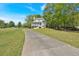 Landscaped two story house with a covered porch set back on a long driveway and big green lawn at 27 Friendship Rd, Euharlee, GA 30145