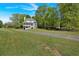 Landscaped two story house with a covered porch and big green lawn in a wooded location at 27 Friendship Rd, Euharlee, GA 30145