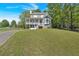 Two story house with a covered porch and a large green lawn in a wooded location at 27 Friendship Rd, Euharlee, GA 30145