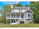 Charming two-story home features a covered porch, bay window, stone facade, and landscaped yard at 27 Friendship Rd, Euharlee, GA 30145
