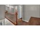 Upstairs hallway featuring a wood banister, neutral carpet, and access to multiple rooms at 27 Friendship Rd, Euharlee, GA 30145