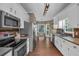Well-lit kitchen boasts modern appliances, sleek countertops, and a breakfast nook with ample natural light at 27 Friendship Rd, Euharlee, GA 30145