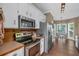 Kitchen featuring stainless steel appliances, white cabinets, and a view of the breakfast nook at 27 Friendship Rd, Euharlee, GA 30145