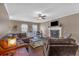 Living room showcasing a cozy fireplace, ceiling fan and laminate wood flooring at 27 Friendship Rd, Euharlee, GA 30145