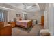 Spacious main bedroom featuring tray ceilings, a ceiling fan, and neutral carpet at 27 Friendship Rd, Euharlee, GA 30145
