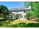 Rear exterior of home with a patio area, sunroom, and spacious yard at 3239 Rose Petal Ln, Powder Springs, GA 30127