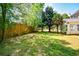 Large backyard with established trees, green grass, and ample open space at 3239 Rose Petal Ln, Powder Springs, GA 30127