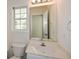 Bathroom featuring a white vanity and a large mirror at 3239 Rose Petal Ln, Powder Springs, GA 30127