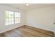 Bedroom with wood-look flooring, a window, and neutral walls at 3239 Rose Petal Ln, Powder Springs, GA 30127