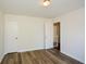 Bedroom with wood-look flooring and view into the hallway through the open door at 3239 Rose Petal Ln, Powder Springs, GA 30127