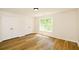 Bedroom with a window, wood-look flooring, and closet with double doors at 3239 Rose Petal Ln, Powder Springs, GA 30127