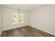 Bedroom featuring wood-look flooring and a large window at 3239 Rose Petal Ln, Powder Springs, GA 30127