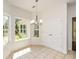 Eat-in dining area featuring lots of windows for natural light and a decorative chandelier at 3239 Rose Petal Ln, Powder Springs, GA 30127