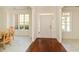 Inviting foyer featuring hardwood floors, ample natural light, and a view into the dining area at 3239 Rose Petal Ln, Powder Springs, GA 30127