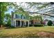 Charming two-story home with a brick facade, inviting porch, and well-maintained lawn at 3239 Rose Petal Ln, Powder Springs, GA 30127