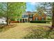 Charming two-story home with a large front yard, mature trees and a welcoming entrance at 3239 Rose Petal Ln, Powder Springs, GA 30127