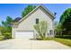 Side view of the home featuring an attached garage and driveway at 3239 Rose Petal Ln, Powder Springs, GA 30127