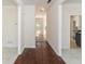 Hallway with tile and hardwood floors leads into kitchen, and features natural light at 3239 Rose Petal Ln, Powder Springs, GA 30127