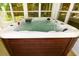 Close up of hot tub filled with water, and built in seating at 3239 Rose Petal Ln, Powder Springs, GA 30127