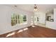 Bright living room with hardwood flooring, a ceiling fan, and seamless transition to kitchen and breakfast nook at 3239 Rose Petal Ln, Powder Springs, GA 30127