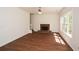 Spacious living room with hardwood flooring, a brick fireplace, and a ceiling fan at 3239 Rose Petal Ln, Powder Springs, GA 30127