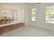 Spacious room with natural light that is open to the dining room, and tile and hardwood floors at 3239 Rose Petal Ln, Powder Springs, GA 30127