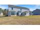 Spacious backyard view of the two story home featuring a covered patio and large lawn at 123 Felicity Pike, Locust Grove, GA 30248