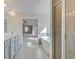 Bright bathroom with double vanity sinks, tile flooring, glass-enclosed shower, and a luxurious bathtub at 123 Felicity Pike, Locust Grove, GA 30248
