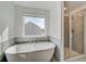 Elegant bathroom featuring a freestanding tub and glass-enclosed shower for a spa-like experience at 123 Felicity Pike, Locust Grove, GA 30248