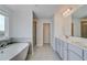 Modern bathroom with a soaking tub, glass-enclosed shower, and double vanity with ample counter space at 123 Felicity Pike, Locust Grove, GA 30248
