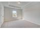 Spacious bedroom with plush carpet, neutral walls, and a large window with outside view at 123 Felicity Pike, Locust Grove, GA 30248