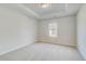 Spacious bedroom with plush carpet, neutral walls, and a large window with outside view at 123 Felicity Pike, Locust Grove, GA 30248