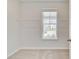 A bright closet with carpeted floors, wire shelving, and a window to the exterior at 123 Felicity Pike, Locust Grove, GA 30248