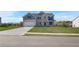 Inviting two-story home with a manicured lawn, brick and gray siding, and a spacious two-car garage at 123 Felicity Pike, Locust Grove, GA 30248