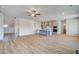 Expansive living room with wood-look floors flowing into a kitchen with a large island at 123 Felicity Pike, Locust Grove, GA 30248