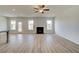 Open-concept living room with wood-look floors, a cozy fireplace, and ample natural light at 123 Felicity Pike, Locust Grove, GA 30248