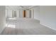Expansive primary bedroom featuring a tray ceiling, plush carpeting, and ample natural light at 123 Felicity Pike, Locust Grove, GA 30248