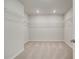 Spacious walk-in closet with carpet flooring and wire shelving for optimal storage and organization at 123 Felicity Pike, Locust Grove, GA 30248