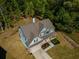 Bird's-eye view of a home surrounded by trees, featuring a well-kept lawn and long driveway, creating a serene landscape at 19 Four Feathers Ne Ln, Rydal, GA 30171