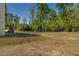 Expansive backyard with a lush lawn and mature trees at 19 Four Feathers Ne Ln, Rydal, GA 30171