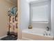 Elegant bathroom features a luxurious soaking tub and a window with natural light at 19 Four Feathers Ne Ln, Rydal, GA 30171