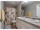 Bathroom featuring a double sink vanity with granite countertops, complemented by a shower/tub combo and decorative accents at 19 Four Feathers Ne Ln, Rydal, GA 30171